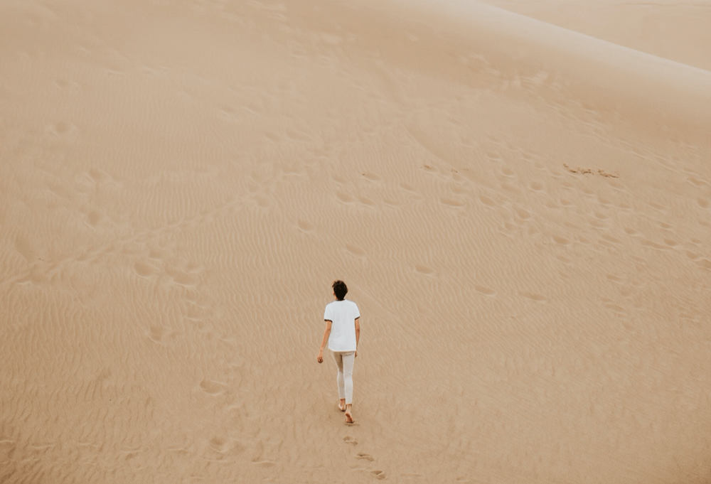 a person walking in a desert